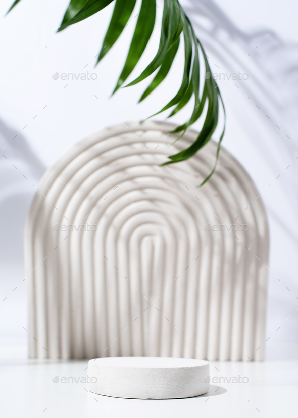 A minimalistic scene of a gypsum podium with stones on white background, for natural cosmetics