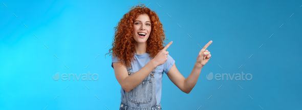 Hey check this out. Enthusiastic redhead curly stylish summer girl inviting beach party pointing