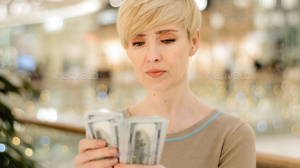 Headshot caucasian middle aged rich woman counting money checking cash salary bonus serious