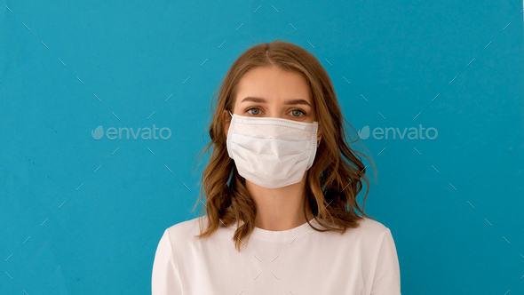 Woman putting on surgical mask for corona virus prevention
