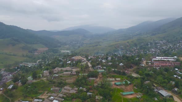 Aerial top view of immigrant refugees residential village houses in countryside, rural area alt