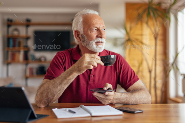 Old man drinking coffee, while working at home office. Stock Photo by ...