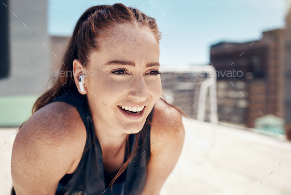 Woman, smile and rest on rooftop for soccer with music, game and happy in sports, workout or fitnes