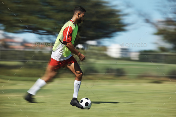 Soccer, sports and man athlete in a football game on sport field running fast and kick in nature. F
