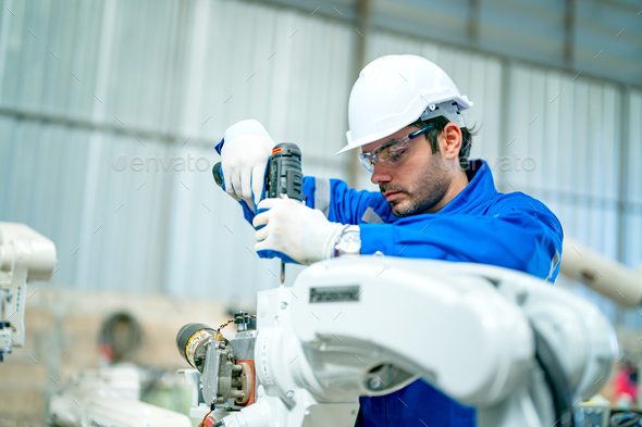 Robotics engineer operating robot aided CNC machine in robotics research facility - Stock Photo - Images