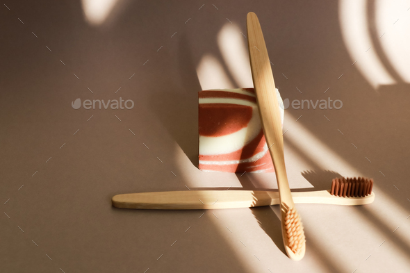Still life with bamboo toothbrushes and soap with contrasting shadows.