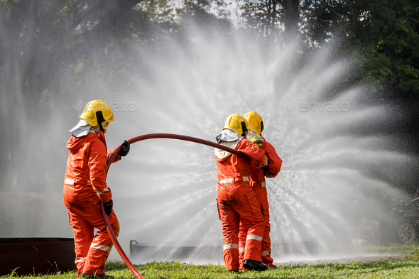 Firefighter Concept. Fireman using water and extinguisher to fighting ...