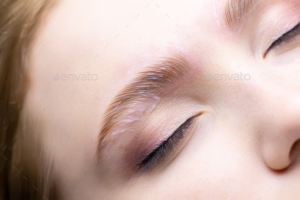 close-up of the laid out hairs and the compositions applied to them for lamination of eyebrows