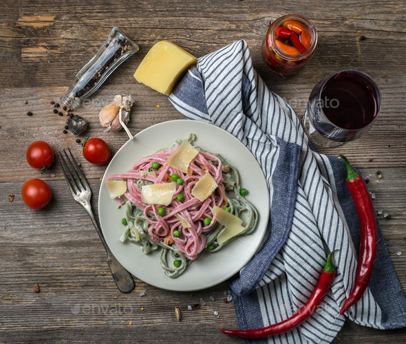 pasta in alfredo sauce, red wine, topview Stock Photo by tan4ikk