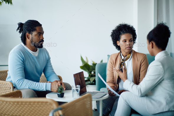 Young black candidate waits while human resource team is discussin gduring job interview.