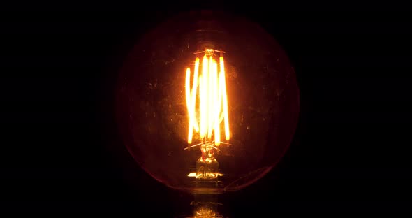 Edison Lamp Flicker At Night. Dirty Light Bulb Glass With Scratches Evokes Horror alt