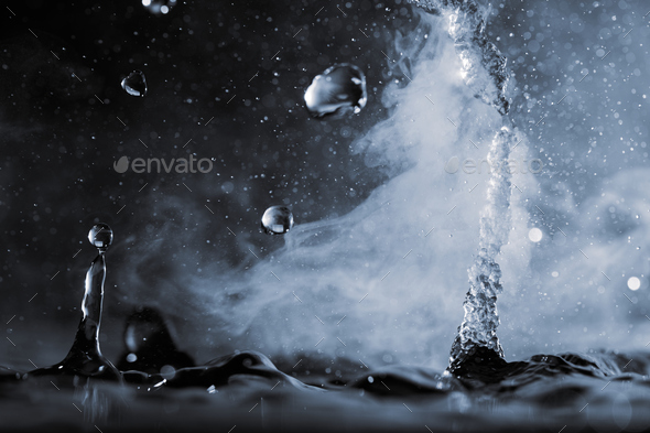 Boiling water splash with steam on black background closeup Stock Photo ...