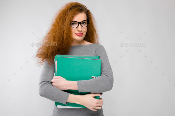 Young woman holding green folder - Stock Photo - Images