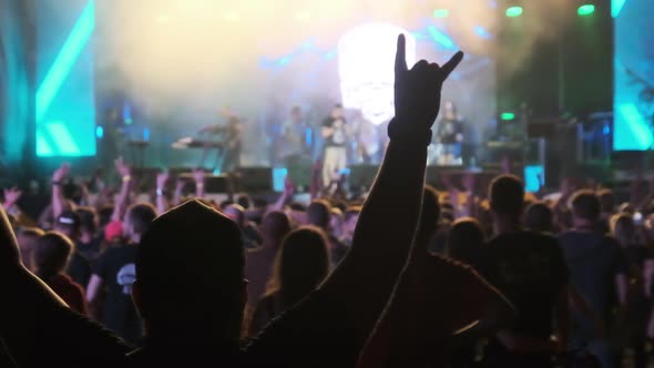 Crowd of Fans at Live Rock Concert Raise Hands and Dance. Slow Motion 240 Fps alt