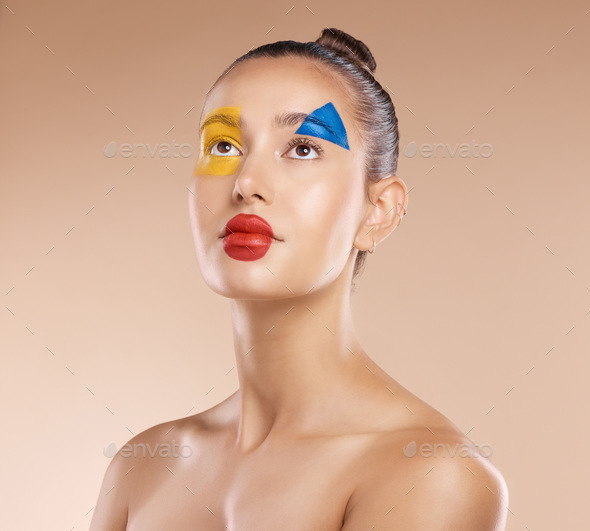 Makeup, clown and young woman with facial art, natural beauty and wellness with brown studio backgr