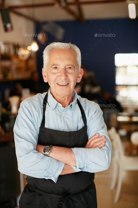 I quit the rat race to open my own cafe. Portrait of a senior man working in a coffee shop.