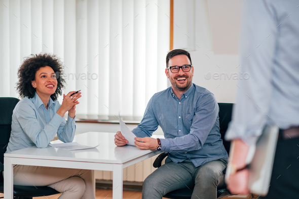 Smiling company hr managers talking to job candidate.