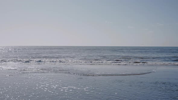 Slowmotion Shot of Light Blue Ocean From the Beach