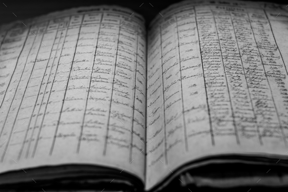 Closeup of an old book of local records with list of residents\' names and information