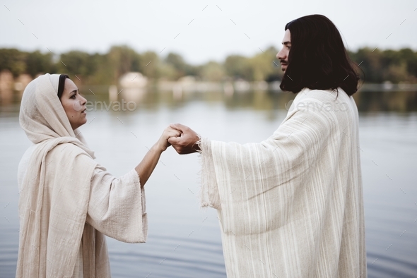 Shallow focus shot of a female wearing a biblical robe and holding the ...