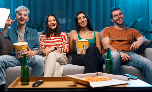 Happy friends watching movies together - Stock Photo - Images