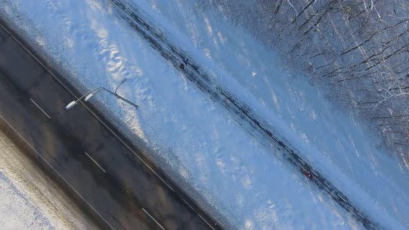 People Jogging on Path near City Road in Winter alt