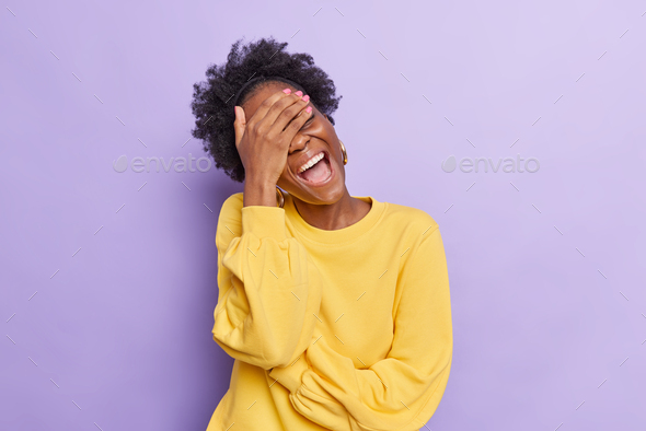 Overjoyed Dark Skinned Young Woman Keeps Hand On Eyes Laughs At Funny Joke Keeps Mouth Wide 1660