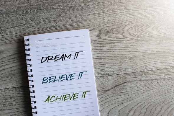 Notebook with text DREAM IT BELIEVE IT ACHIEVE IT.