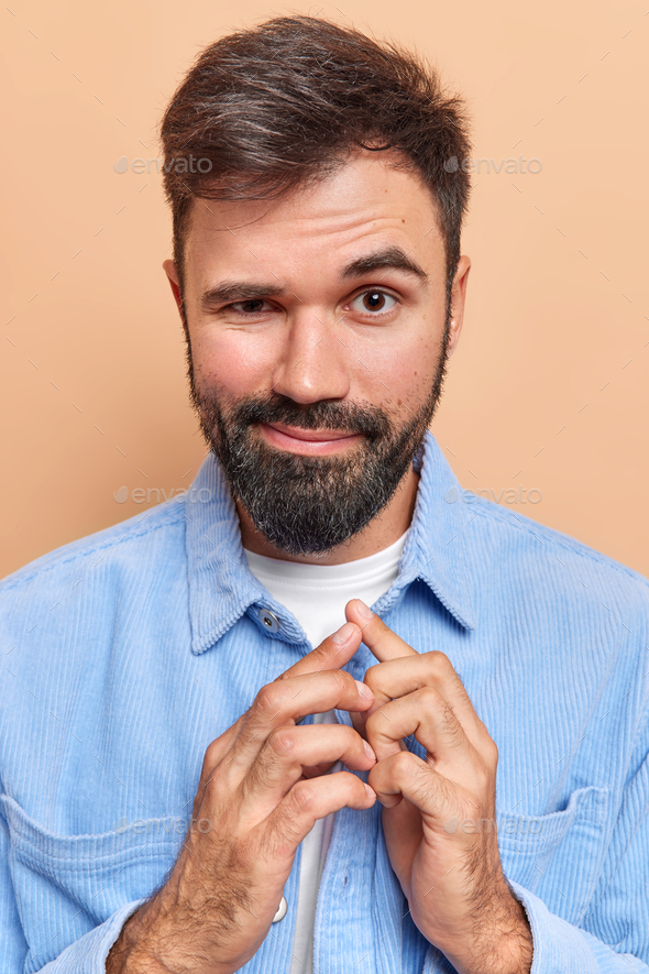 Isolated shot of unhappy desperate man with stubble keeps hands on head,  wears fashionable clothing - denim jacket, hat and eyewear, poses against  pink background. Forgetful male poses indoor 7673080 Stock Photo