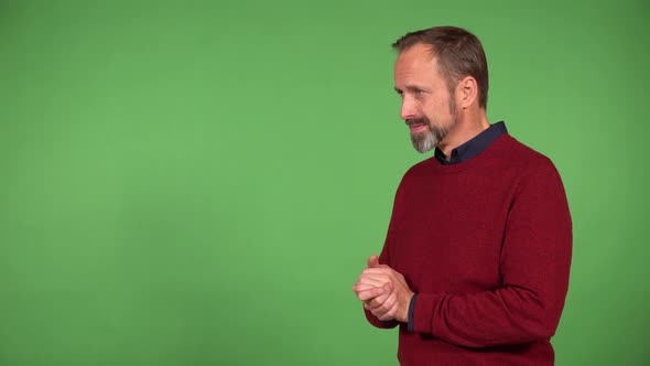 A Middleaged Handsome Caucasian Man Applauds to the Camera with a Smile  Green Screen Background