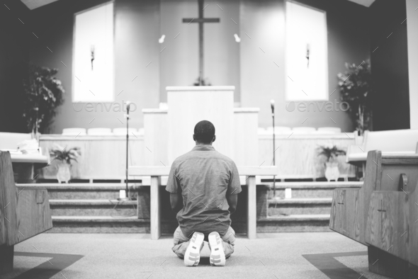 man praying on knees