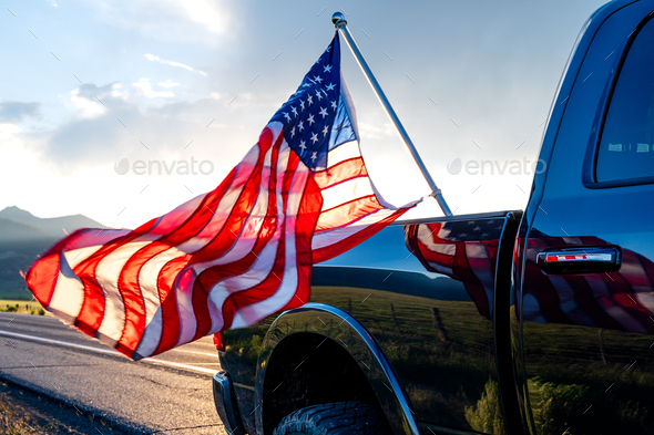 USA flag sticking from the black pickup truck cargo in Bridgeport, California, USA - Stock Photo - Images
