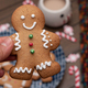 Woman hand holding a gingerbread man cookie - PhotoDune Item for Sale