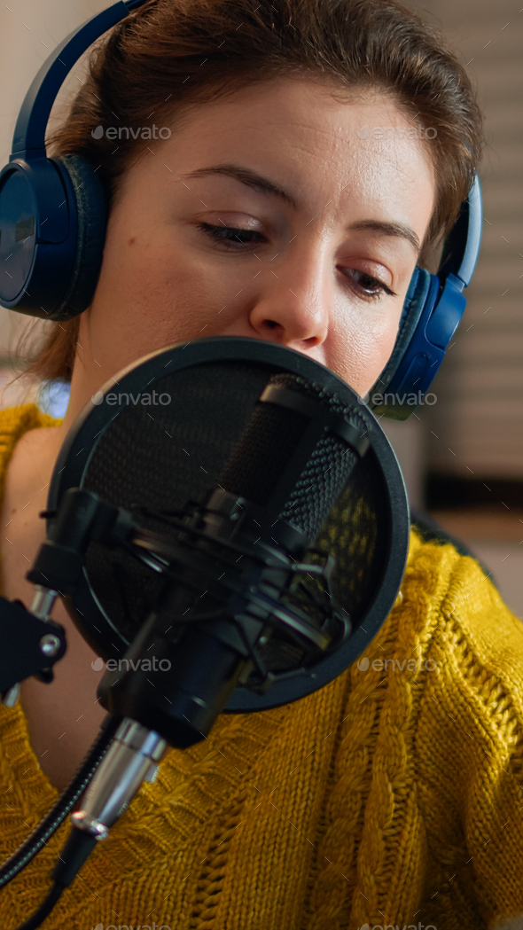 Creative blogger wearing headphones checking sound