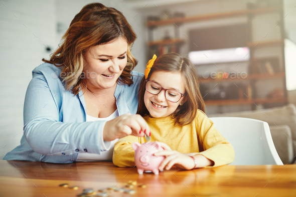 piggy bank mother daughter money savings coin finance child family happy investment