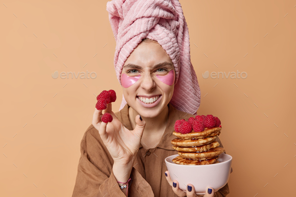 Positive Young Woman Smirks Face And Shows White Teeth Has Fun While