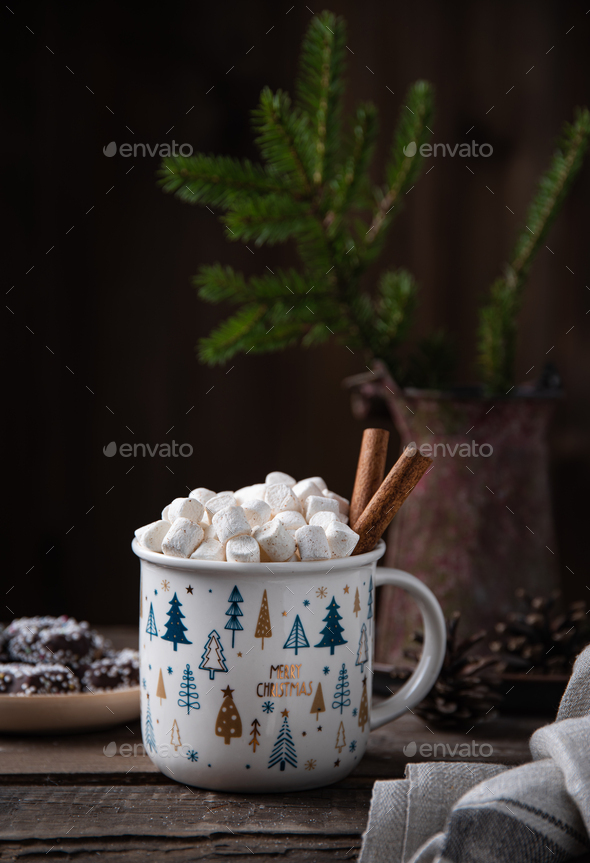 Christmas cup of cacao and marshmallow with cinnamon on an old brown wooden table with cookies