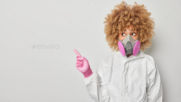 Horizontal shot of impressed curly woman does chemical work dressed in ...