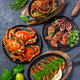 Set of Seafood Dishes. Crabs, octopus, squids and tiger shrimps on cast iron pans and plates - PhotoDune Item for Sale