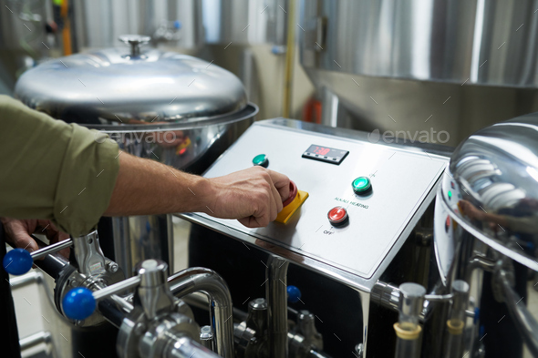 Worker Launching Brewery Equipment - Stock Photo - Images