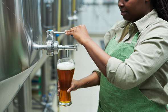 Brewery Worker Filling Glass with Beer