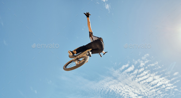 Bicycle stunt, man cycling in air jump on blue sky mock up for sports action performance, fitness t