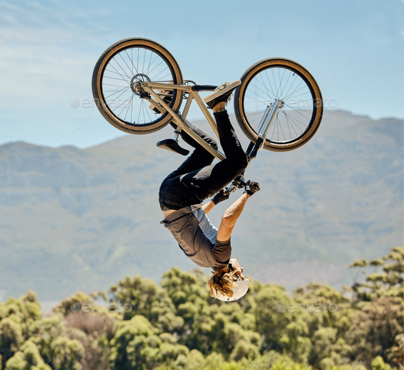 Mountain bike, man and upside down air jump, action and bicycle stunt, challenge and adventure, fre
