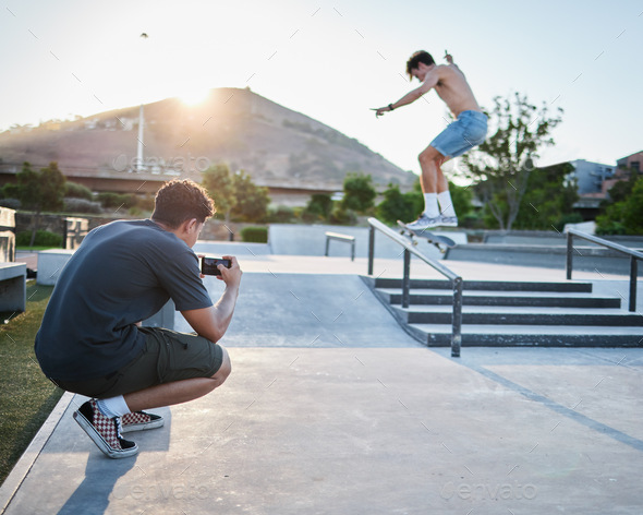 Skateboard jump outdoor, photographer in park for extreme sports photoshoot with skater in summer.