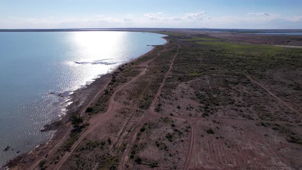 A White Car Drives Along Beach of Lake Balkhash alt