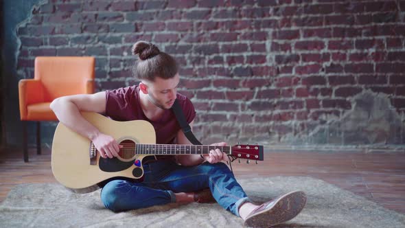 Handsome Young Man Playing Acoustic Guitar Sitting Floor Living Loft Room