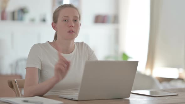 Rejecting Beautiful Young Woman Waving Finger in Denial While Using Laptop alt