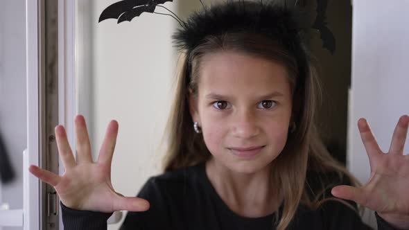 Closeup Cute Girl Scaring Looking at Camera Gesturing Appearing From House alt