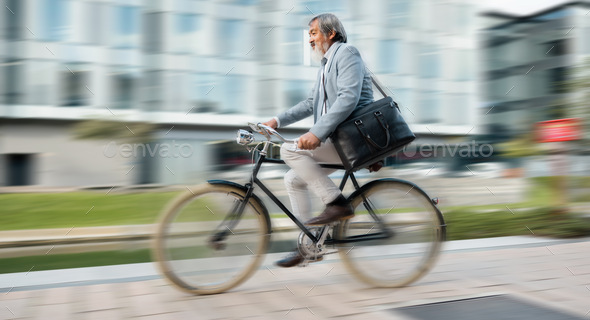 Bike, commute and blurred motion with a mature man in business cycling in the city on his morning t