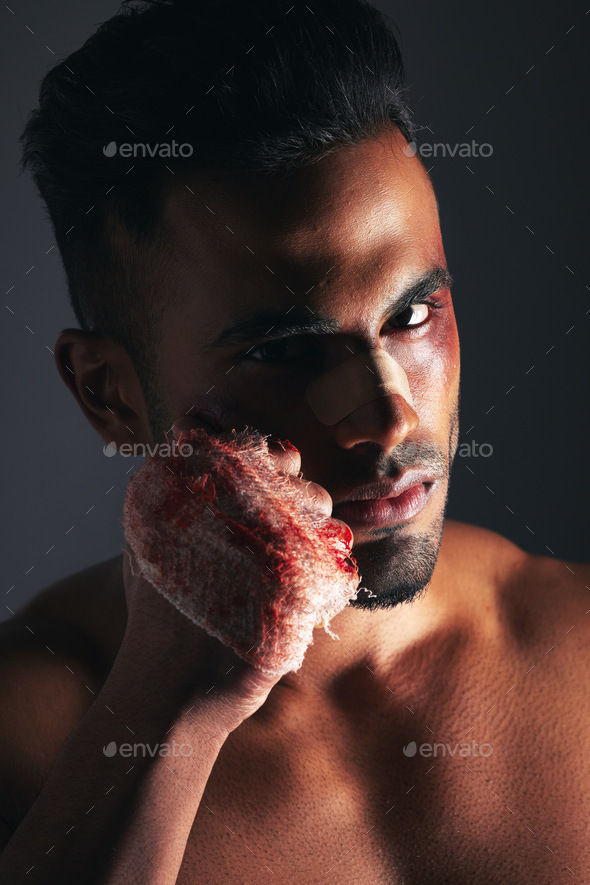 Violence, man and portrait with blood fist of angry fighter with bruise, injury and wound plaster.